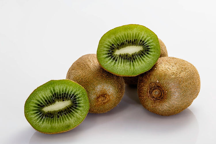 kiwis picados encima de una mesa blanca