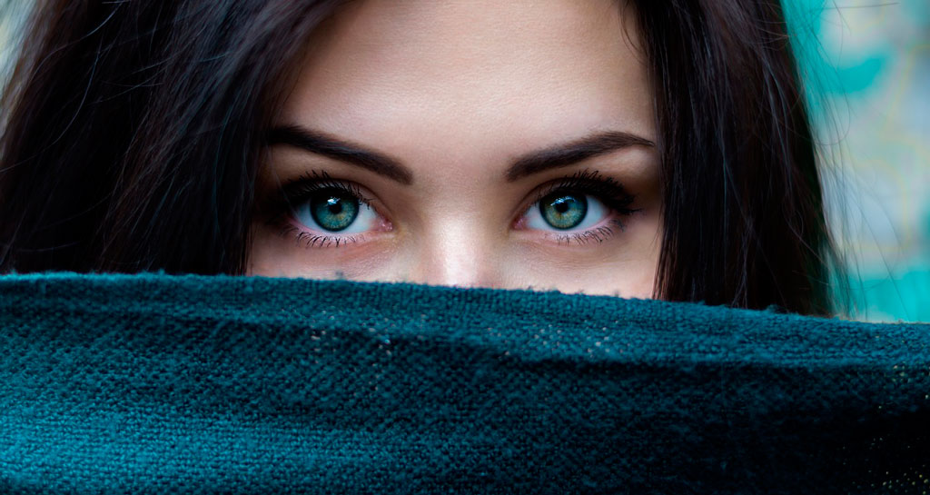 mujer mostrando bellos ojos verdes con piel sin granos